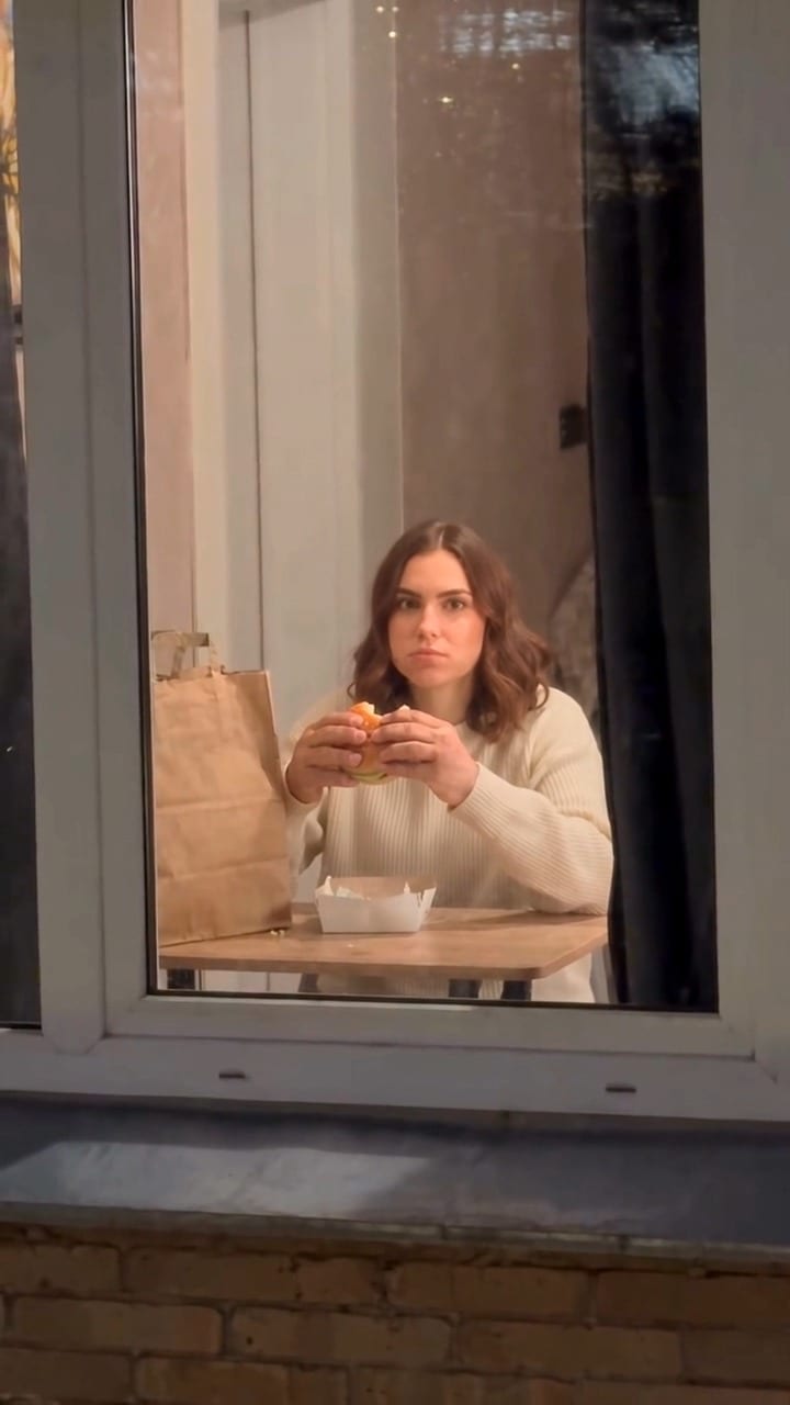 The person inside looks up at the camera.